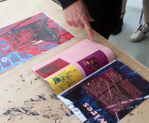 En kursdeltagare på designskolan pekar på en bild En kursdeltagares hand pekar på en bild i en tidning på designskolan på Ölands Folkhögskola